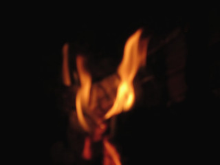 Fototapeta premium Blurred flames in a burning fireplace on black background