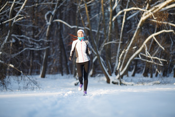 Sportswoman on jogging in winter