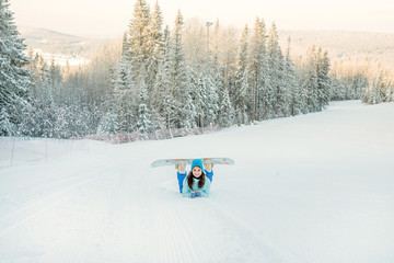 Girl with a snowboard on the ski slope