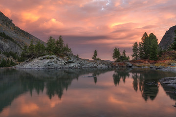 Rocks And Trees Reflecting In Pink Waters Of Sunset Mountain Lake, Altai Mountains Highland Nature Autumn Landscape Photo