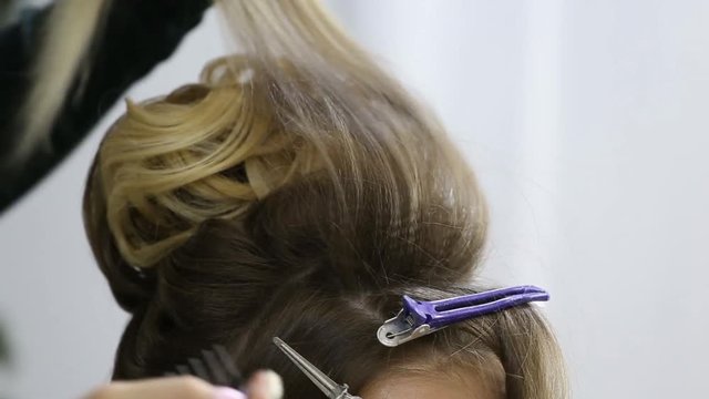 Professional hairdresser making bouffant at hair strands and creating volume, Close-up hairstyle