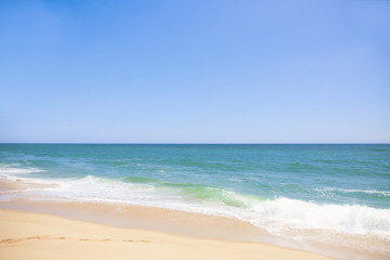 Fototapeta na wymiar The coast of blue ocean and sand beach