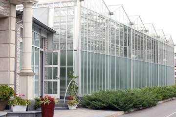 Entrance of glass greenhouse in village