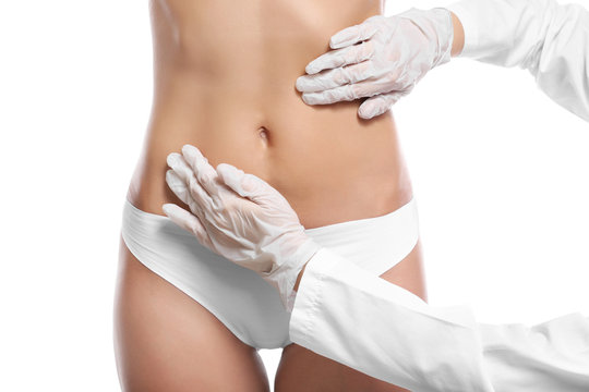 Surgeon examine female body before plastic operation on white background