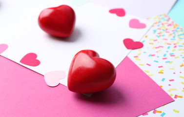 Red decorative heart on color paper background