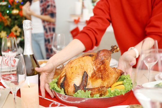 Woman serving turkey for Christmas dinner, close up view