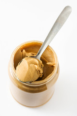Creamy peanut butter and spoon isolated on white background
