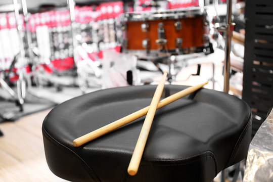 Drumsticks on stool in music shop