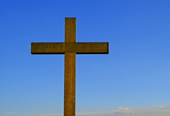 Wooden cross on sky background