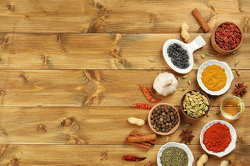 Aromatic spices on wooden background