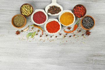 Aromatic spices on wooden background