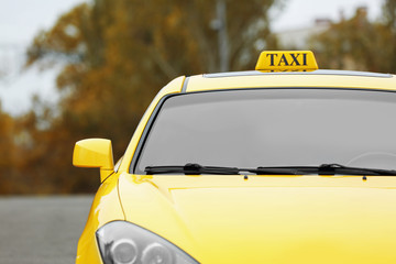 Yellow car with taxi sign on roof, outdoor