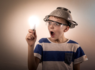 Boy with a lighted bulb in the hand