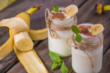 Organic homemade sweet milk dessert with banana, cinnamon and mi