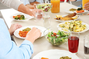 Family having lunch in kitchen, closeup