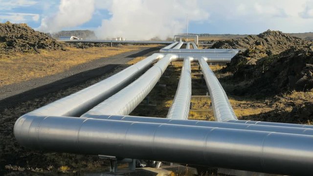 pipes of icelandic Power Plant in Reykjanes peninsula, geothermal stations steam is on background