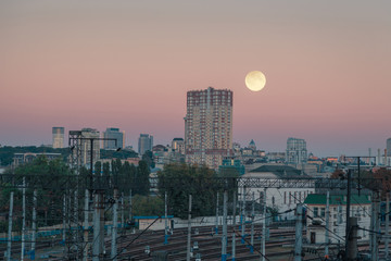 Moon over Kyiv city. Ukraine. Downtown and railways station.