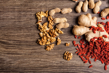 Dried fruits and nuts on wooden background