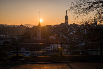 Naklejka premium A cityscape of Bern, medival city in Switzerland in the late evening with a soft fog.