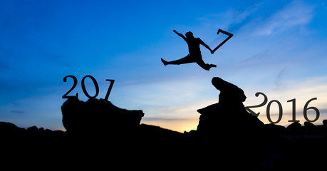 Silhouette man jumping between 2016 and 2017