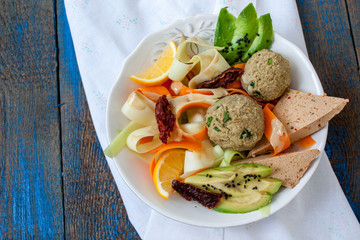 Zucchini pasta with tofu lentil balls, avocado, carrots. Vegan healthy lunch or dinner. Love for a healthy raw food