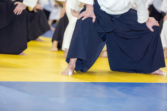 People warming up on Aikido martial arts training. Selective focus