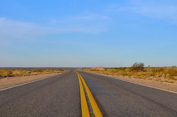 Close up asphalt with yellow lines at La Pampa dessert in Patagonia, Argentina