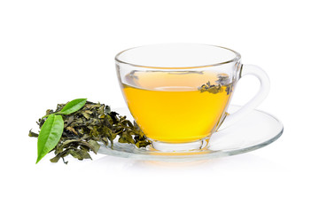 green tea leaf with a glass of tea on white background