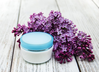 Fototapeta na wymiar moisturizing cream and lilac flowers