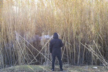 Naklejka na ściany i meble Man with smoke on his head in a lonely place, concept loneliness