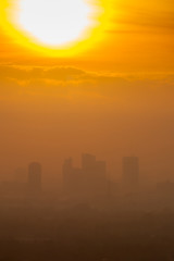 Sunrise over downtown Bangkok in cloudy day.  Silhouette citysca