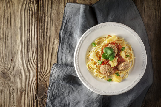 Ready-made spaghetti with meatballs and herb at the board