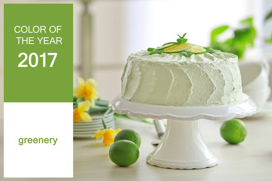 Trendy color concept. Tasty cake on stand. Text COLOR OF THE YEAR 2017 GREENERY on background