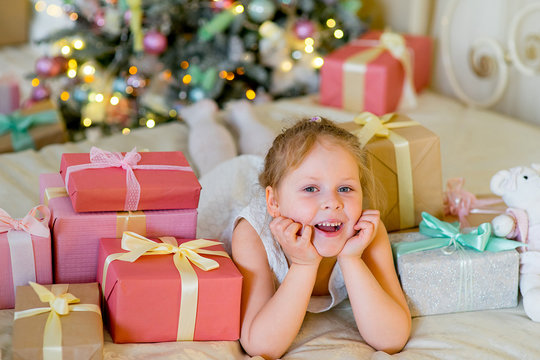 Happy blonde girl with Christmas gifts