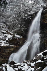 Fototapeta premium Waterfall from ravine in winter, long exposure