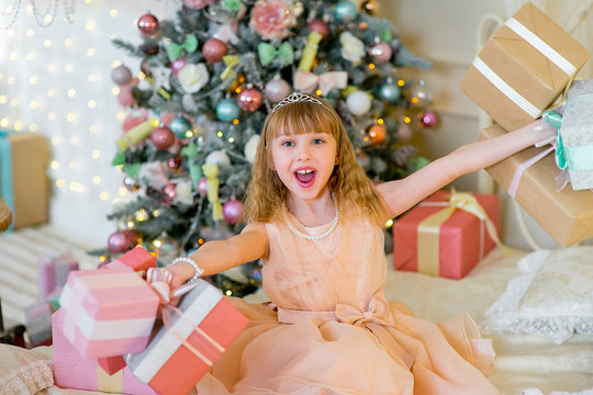 Adorable blonde girl with Christmas gifts