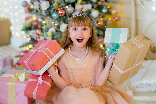 Adorable blonde girl with Christmas gifts
