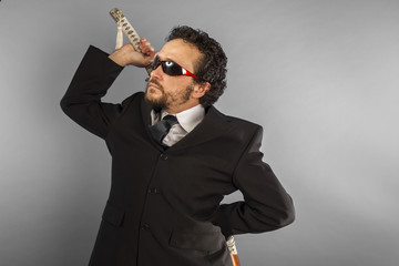 Dark businessman, aggressive lawyer with Japanese sword, defiant