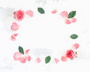 Frame made of rose flowers. Flat lay, top view