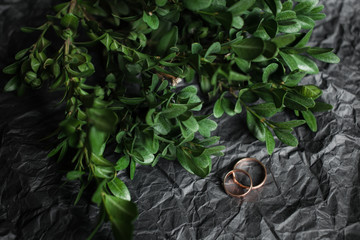 Wedding. Wedding rings on kraft Bumacov with green leafy plants. Wedding rings on a branch.