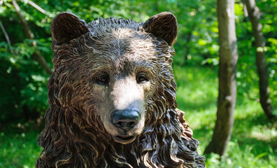 Carved wooden bear head in park