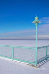 Aqua Light Post with View of Frozen Horizon on a Sunny Wintertime Day