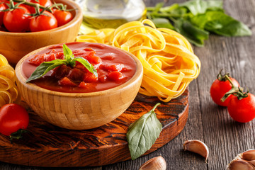 Products for cooking - tomato sauce, pasta, tomatoes, garlic.