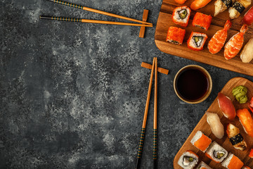 Fototapeta na wymiar Sushi Set: sushi and sushi rolls on wooden plate.