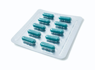 Aluminium blister pack of pills. The capsules are packaged in blisters, isolated on a white background. Disease. Flu. Medications.