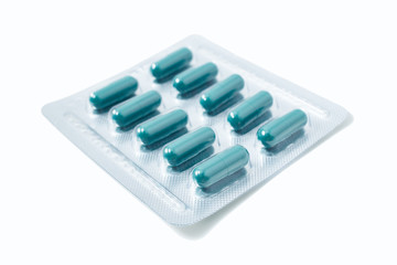 Aluminium blister pack of pills. The capsules are packaged in blisters, isolated on a white background. Disease. Flu. Medications.