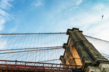 Naklejka premium Brooklyn Bridge in New York City at sunset. Vivid splittoned image.
