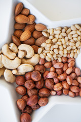 Mixed nuts in a dish in the form of stars, close-up