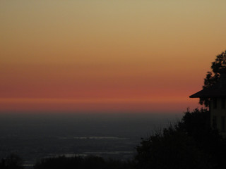 Stunning gradation of pastel yellow and pink of the after sunset sky, Bergamo, Italy 