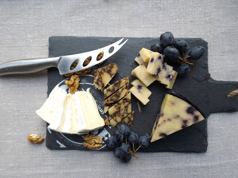 Cheeseboard. Brie cheese, seasoned in Porter cheese and cheese with blueberries